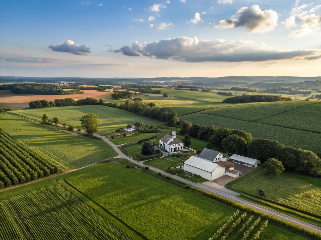 A picturesque view of a sprawling farm property with a well-maintained farmhouse, representing property loans. The image should evoke a sense of stability and long-term investment.